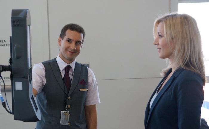 DeltaAirLines DTW_Employee Guiding Customer through Facial Recognition Boarding